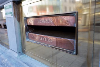 A box in English and Irish writing for posting letters at a main Post Office. Cork