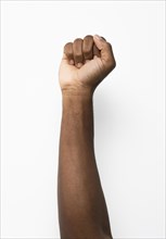 Black person holding fist up