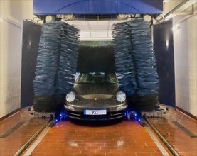 Porsche 911 sports car in a car wash