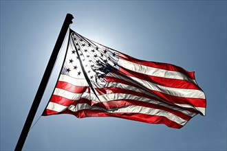 American flag in front of the sun