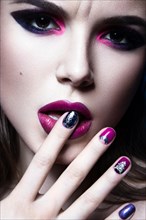 Beautiful girl with bright creative fashion makeup and colorful nail polish. Art beauty design. Photos shot in studio