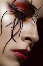Portrait of woman in the image of spider with creative art makeup. beauty face. Close up. Photos shot in studio