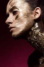 Beautyful girl with gold glitter on her face.Art image beauty face. Picture taken in the studio