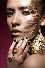 Beautyful girl with gold glitter on her face.Art image beauty face. Picture taken in the studio