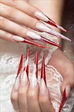 Long beautiful manicure with lace on female fingers. Nails design. Close-up