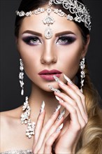 Beautiful girl in the image of the Arab bride with expensive jewelry