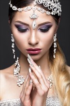 Beautiful girl in the image of the Arab bride with expensive jewelry
