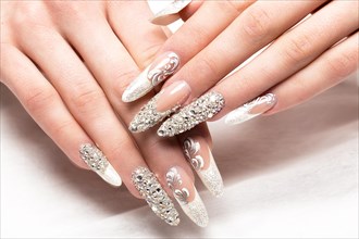 Beautifil wedding manicure for the bride in gentle tones with rhinestone. Nail Design. Close-up