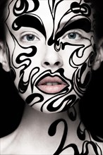 Beautiful girl with art black and white makeup and nails. Creative beauty face. Photo taken in the studio