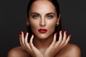 Beautiful girl with a classic make up and multi-colored nails. Manicure design. Beauty face. Photo taken in the studio