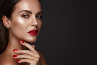 Beautiful girl with a classic make up and multi-colored nails. Manicure design. Beauty face. Photo taken in the studio