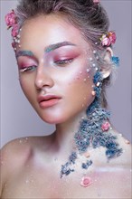 Beautiful girl in the image of a sweet fairy with art make up. Creative look. Photo taken in the studio