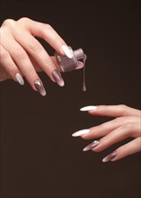 Beautiful classic manicure on female hand with nail polish. Close-up. Picture taken in the studio