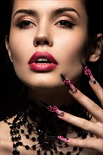 Beautiful girl with long nails and sensual lips. Portrait shot in the studio on a black background.Beauty face