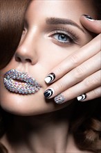 Beautiful girl with bright nails and lips of crystals