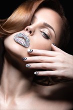 Beautiful girl with bright nails and lips of crystals