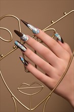 Creative design of nails on female hands. Art manicure. Photo taken in studio