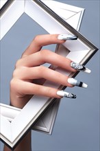 Creative gradient design of nails on female hands. Art manicure. Photo taken in studio
