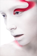 Art fashion girl with white skin and red paint on the face. Creative art beauty. Picture taken in the studio on a white background