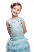 A little girl in a blue dress