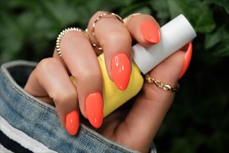 Bright neon manicure on female hands with accessories. Nail design. Beauty hands