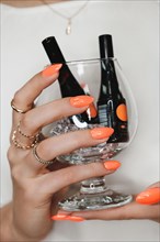 Bright neon manicure on female hands with accessories. Nail design. Beauty hands