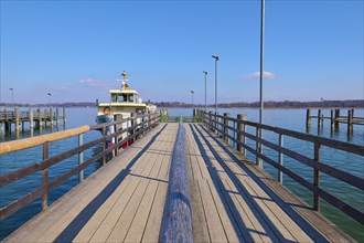 Lake Ciemsee with pier and excursion boat
