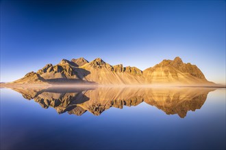 Mountain massif reflected in water