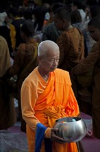 Buddhist monk collecting donations in the morning