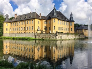 View over moat with reflection on moated castle Schloss Dyck