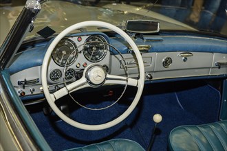 View of the interior of a historic sports car Classic Car Mercedes 190 SL cabriolet Roadster Steering wheel analogue round instruments