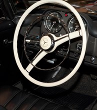 Steering wheel instrument panel with analogue round instruments of historic sports car classic car Mercedes Benz 190 SL