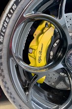 Detail of yellow brake caliper of limited edition 500 pieces Italian sports car Alfa Romeo Giulia GTAm
