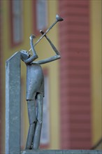 Modern sculpture as trumpeter made of metal