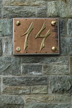 House number 14 made of brass with copper and rivets