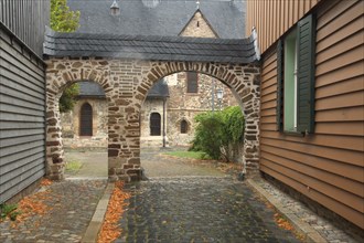 Stone wall with archway and view of St. Johannis Church