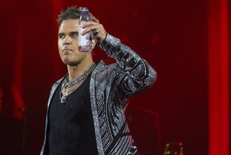 Robbie Williams with a bottle of water