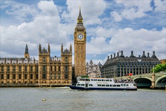 Excursion boat on the Thames with the Houses of Parliament and the clock tower Big Ben