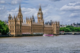 Excursion boat on the Thames with the Houses of Parliament and the clock tower Big Ben