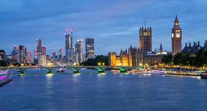 Westminster Bridge over the Thames with skyline and Houses of Parliament at dusk