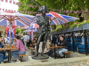 Statue of Admiral Lord Nelson in seating area outside the Trafalgar pub
