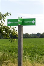 Footpath sign with direction arrows in three directions