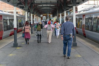 Passengers walking from trains on platform at Norwich railway station