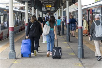 Passengers walking from trains on platform at Norwich railway station