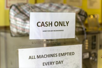 Cash Only sign on window of launderette