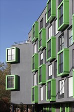 Modern apartment house with green bay windows