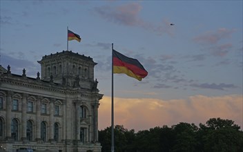 German flags flying at sunset at the Reichstag