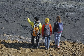 Hikers look down on solidified lava