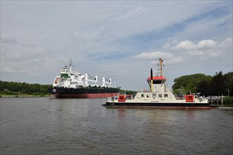 Cargo ship and car ferry on the Kiel Canal near Fischerhuette