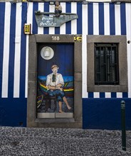 Colourfully painted door with fisherman